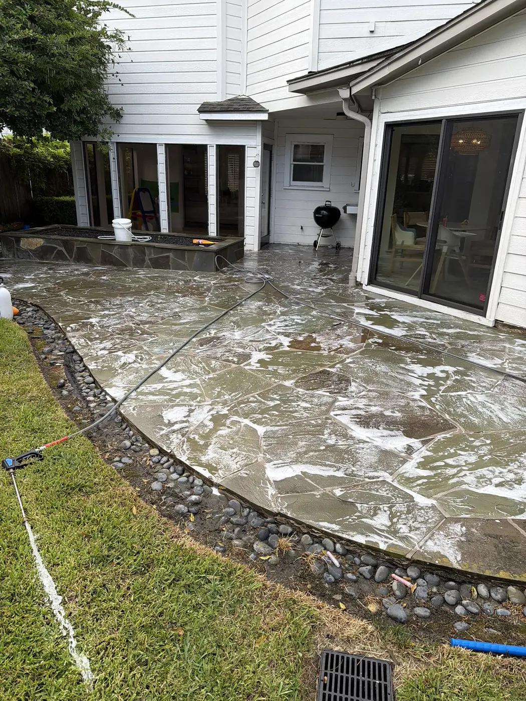Flagstone patio being cleaned with soapy solution in Houston